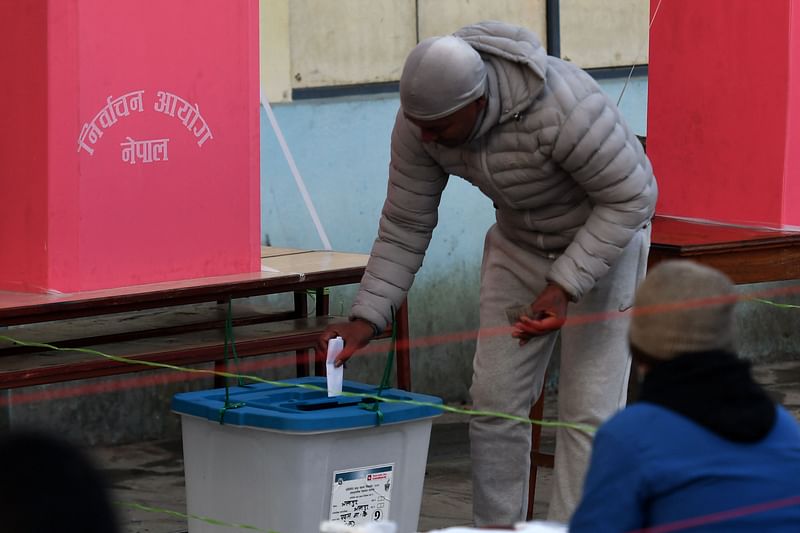 A voter casts his ballot in the general election at a polling station in Bhaktapur on the outskirts of Kathmandu on 20 November, 2022