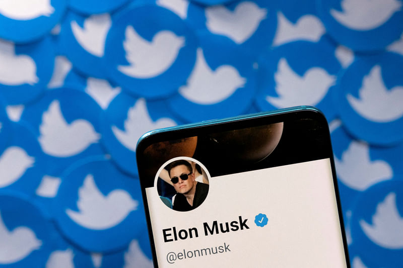 Elon Musk's Twitter profile is seen on a smartphone placed on printed Twitter logos in this picture illustration taken 28 April, 2022.