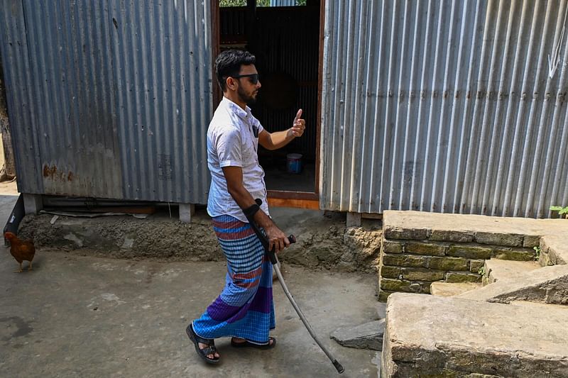 In this photograph taken on 6 November, 2022, former migrant worker Babu Sheikh, who lost his sight after a work accident at a construction site in Qatar, walks at his house in Sadarpur