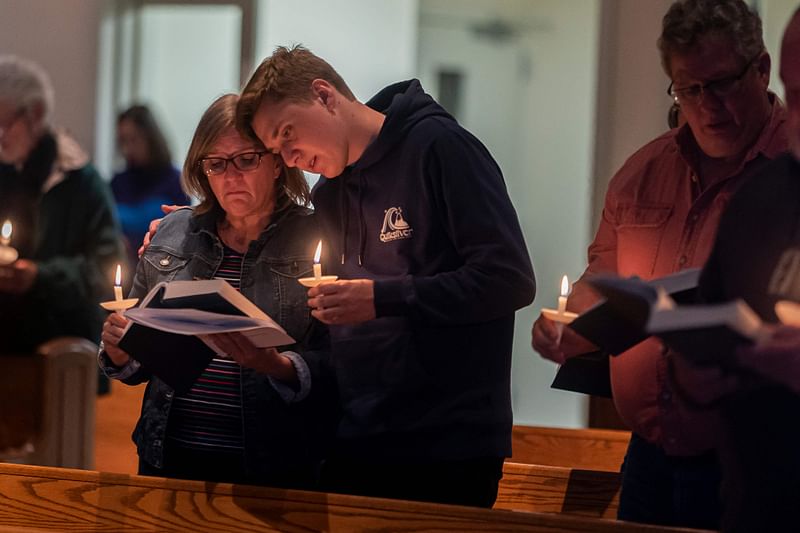 Mourners listen to a prayer during a vigil at St. Thomas Episcopal Church for those killed in a fatal shooting at a Walmart on November 23, 2022 in Chesapeake, Virginia