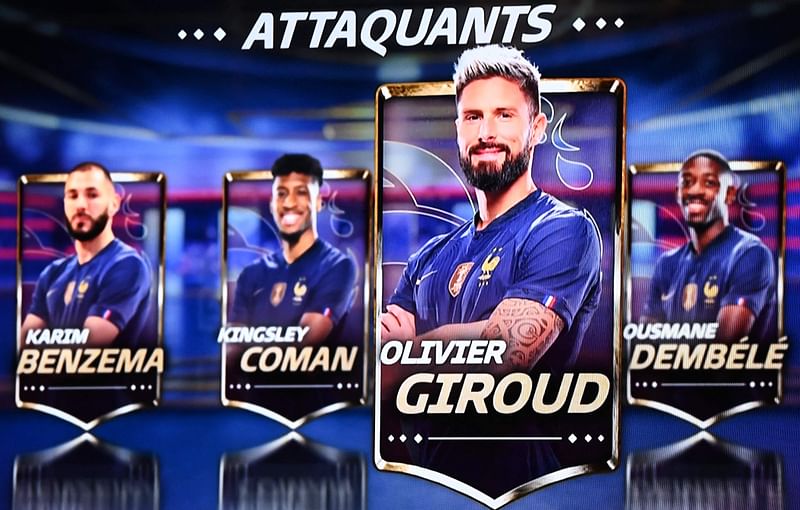 This screen shot made in Paris on 9 November, 2022 shows (from L to R) France's forward Karim Benzema, France's forward Kingsley Coman, France's forward Olivier Giroud and France's forward Ousmane Dembele displayed on a screen during the evening news broadcast of French TV channel TF1