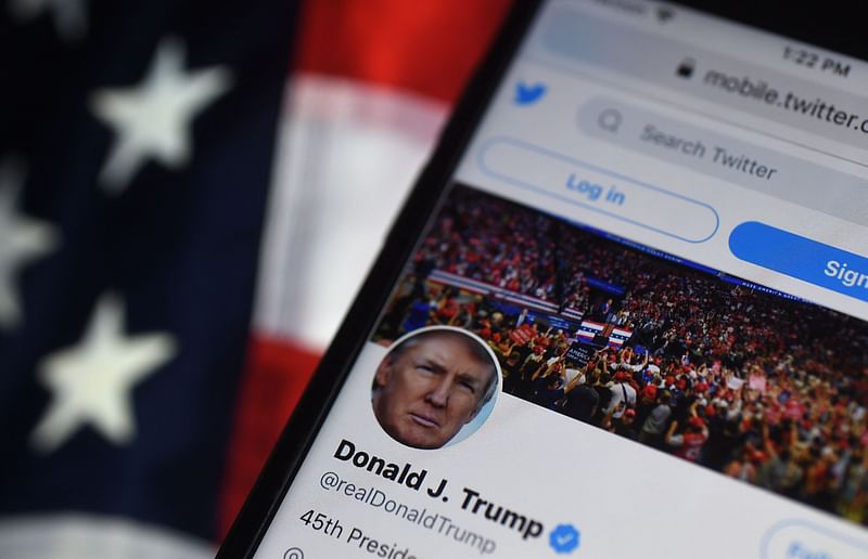 In this file photo illustration taken on August 10, 2020, the Twitter account of US President Donald Trump is displayed on a mobile phone in Arlington, Virginia. Trump's once-blocked Twitter account reappeared on the platform on 17 November, 2022