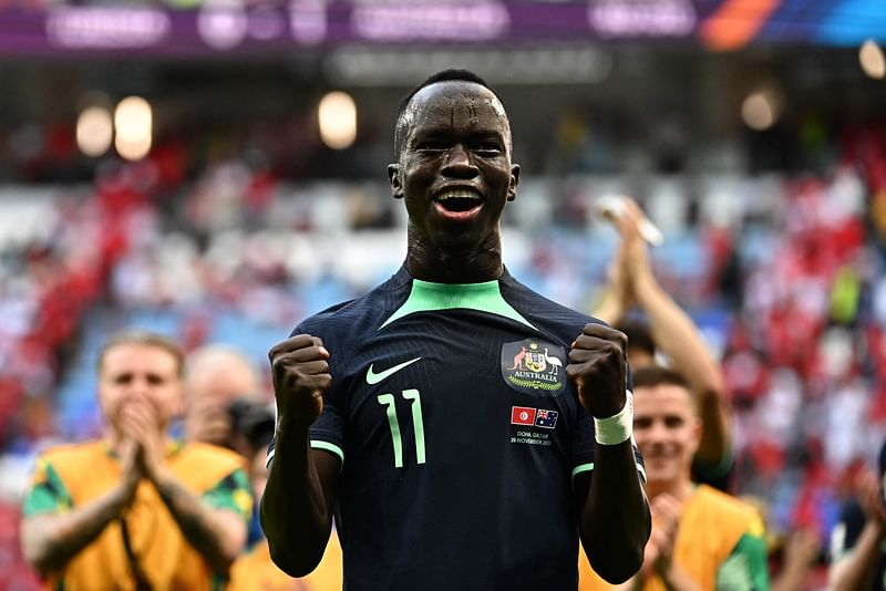 Australia's forward #11 Awer Mabil celebrates after winning the Qatar 2022 World Cup Group D football match between Tunisia and Australia at the Al-Janoub Stadium in Al-Wakrah, south of Doha on 26 November 2022