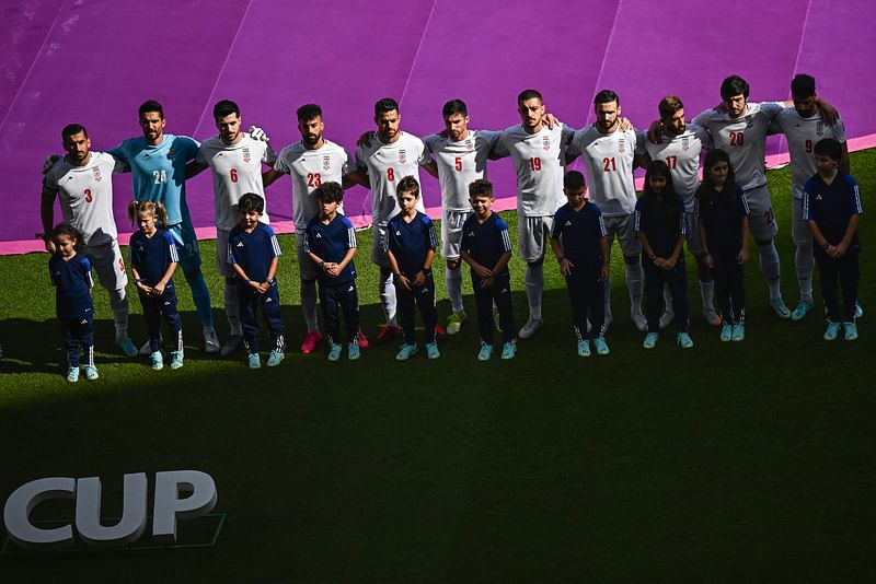 Iran players stand for the national anthem ahead of the FIFA World Cup 2022 Group B match between Wales and Iran at the Ahmad Bin Ali Stadium in Al-Rayyan, west of Doha on 25 November, 2022