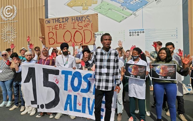 Climate activists demonstrate calling upon the G20 conference to adhere to limit global temperature rise to 1.5 degrees Celsius compared to pre-industrial levels, at the Sharm el-Sheikh International Convention Centre, in Egypt's Red Sea resort city of the same name, during the COP27 climate conference, on 16 November 2022.