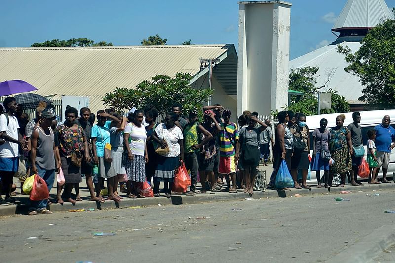 Residents stay in the open in downtown of Honiara on 22 November, 2022, as people rushed from their offices and fleeing to higher ground after a strong earthquake