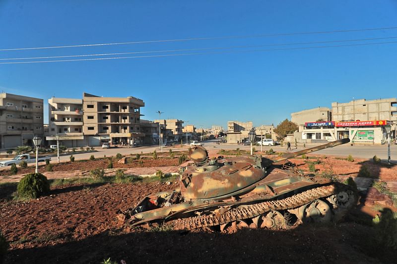 A pictue shows a view of a half-buried tank at the "Free Woman" square in the Syrian Kurdish town of Kobane, also known as Ayn al-Arab, in the north of the Aleppo governorate on November 20, 2022. Turkey announced it had carried out air strikes against the bases of outlawed Kurdish militants across northern Syria and Iraq, which it said were being used to launch "terrorist" attacks on Turkish soil