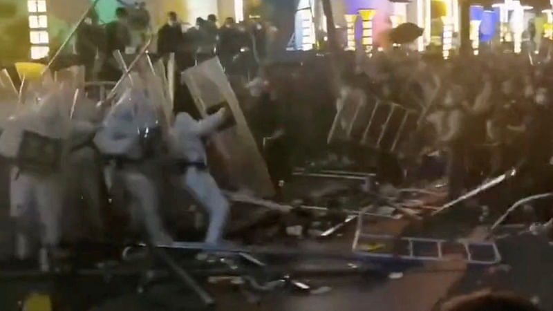 Security forces clash with workers during a protest outside Apple supplier Foxconn’s factory in Zhengzhou, China on 23 November, 2022 in this still image obtained by REUTERS from a video