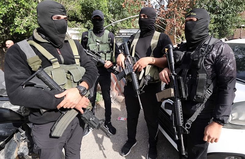 Palestinian gunmen attend the funeral of a youth who was reportedly killed during a raid by Israeli forces on 21 November, 2022 in the West Bank city of Jenin