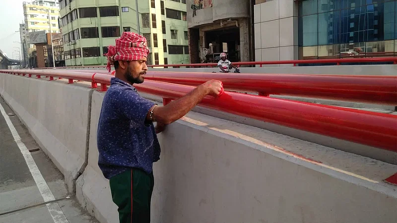 A worker puts the finishing touches at an elevated expressway in Dhaka.