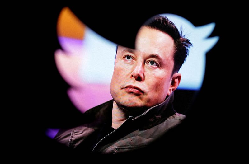 Elon Musk's photo is seen through a Twitter logo in this illustration taken 28 October, 2022.