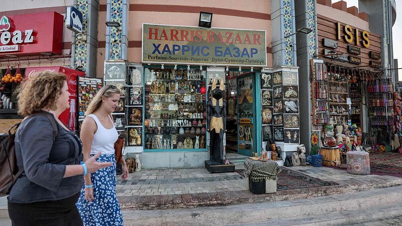 People walk past tourist bazaars in the old market area of Egypt's Red Sea resort city of Sharm el-Sheikh during the COP27 climate conference on 19 November, 2022.