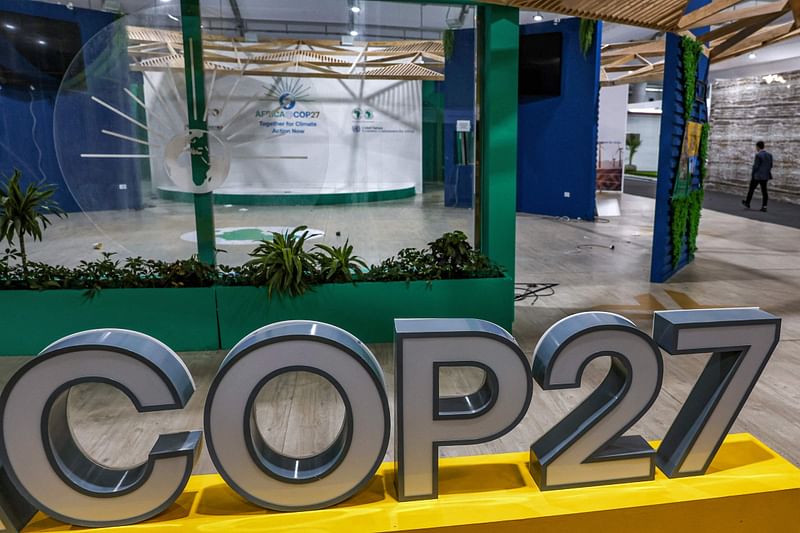 A person walks near the COP27 climate conference at the deserted hall at the Sharm el-Sheikh International Convention Centre, in Egypt's Red Sea resort city of the same name near the end of the climate conference on 19 November, 2022.