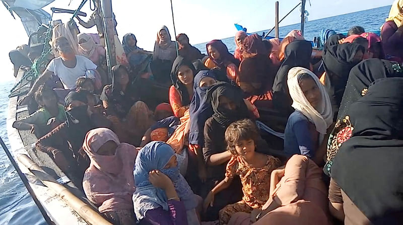 A boat carrying Rohingya refugees, including women and children, is seen stranded in waters off the coast of Bireuen, Aceh province, Indonesia, 27 December, 2021, in this still image taken from a video. Video recorded on 27 December, 2021.