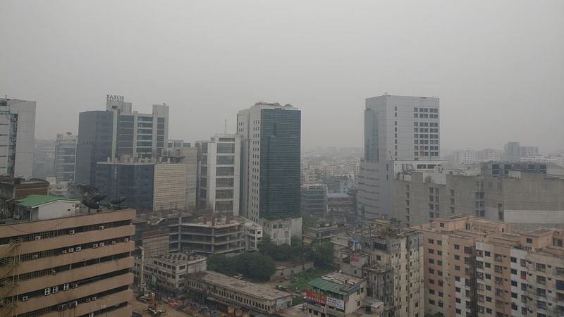 Smog is seen beyond the high rise buildings in Dhaka