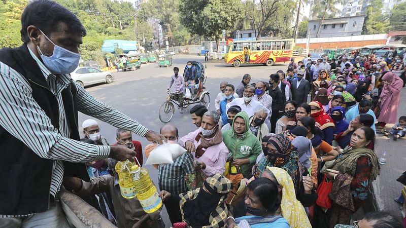 People wait in a long queue to buy daily necessities at a fair price from Trading Corporation of Bangladesh (TCB). The picture was taken from Jamal Khan area in Chattogram.