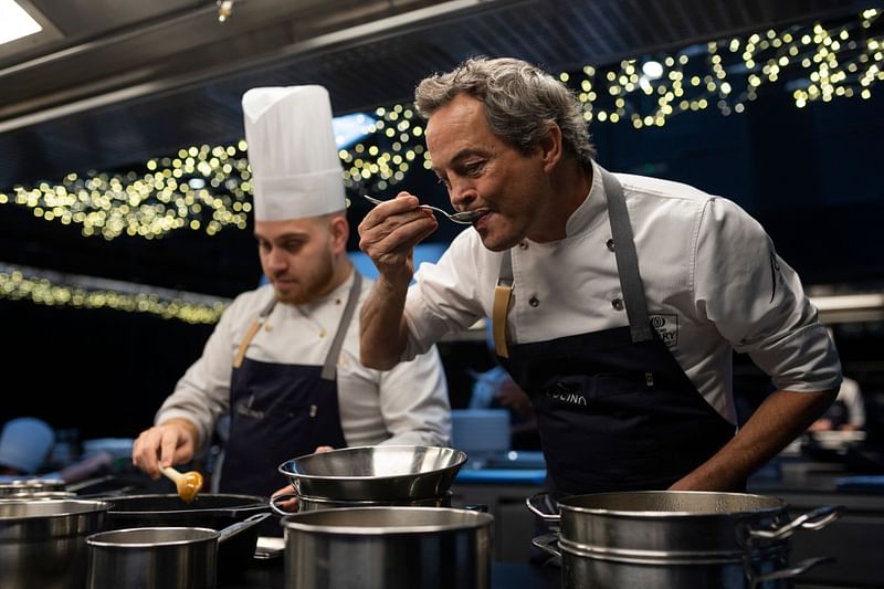 In this photograph taken on 1 December, 2022 Spanish chef, Javier Torres tastes a meal in the kitchen of his restaurant 'Cocina Hermanos Torres' after receiving the distinction of three-stars from the Michelin guide, in Barcelona.