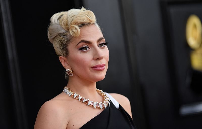 In this file photo taken on 3 April, 2022 US singer-songwriter Lady Gaga arrives for the 64th Annual Grammy Awards at the MGM Grand Garden Arena in Las Vegas. A man who shot Lady Gaga's dog-walker during an attempt to steal the singer's prize French bulldogs was sentenced to 21 years in prison on 5 December, 2022 after pleading no contest to attempted murder. James Howard Jackson and two other men attacked Ryan Fischer on a Hollywood street in February 2021, and after a struggle made off with two of the "Poker Face" singer's three pets that were out for a walk.