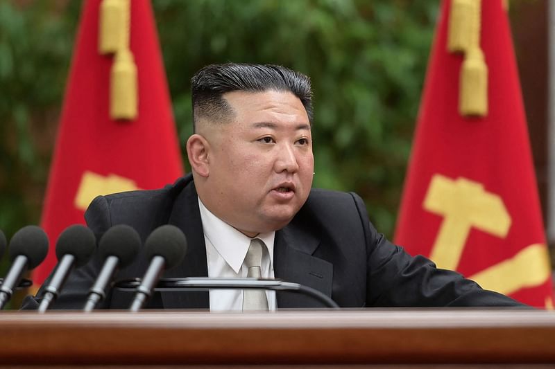 This picture taken on 27 December, 2022 and released from North Korea's official Korean Central News Agency (KCNA) on 28 December, 2022 shows North Korea's leader Kim Jong Un giving a report on the second day of the 6th expanded plenary session of the 8th Central Committee of the Workers' Party of Korea