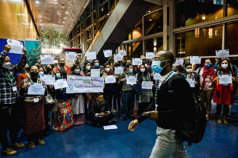 Protestors from the International Indigenous Forum on Biodiversity (IIFB) demonstrate outside of the room where negotiators are meeting to discuss Target 3 (30x30 target) at the United Nations Biodiversity Conference (COP15) in Montreal, Quebec, Canada on 10 December, 2022.