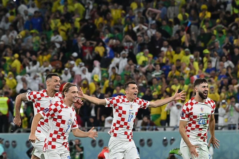 Croatia's midfielder Lovro Majer, Croatia's defender Dejan Lovren, Croatia's forward Ante Budimir and Croatia's defender Josko Gvardiol celebrate as they win on penalty shoot-out the Qatar 2022 World Cup quarter-final football match between Croatia and Brazil at Education City Stadium in Al-Rayyan, west of Doha, on 9 December 2022