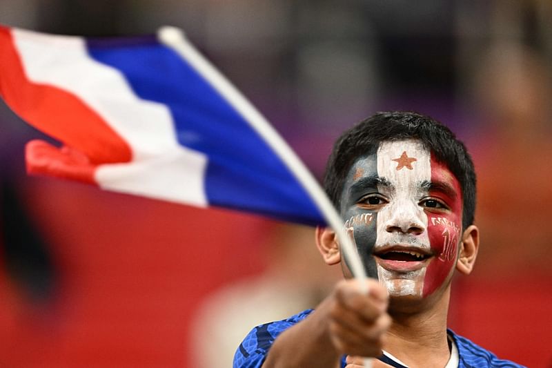 A youth waves the national flag of France