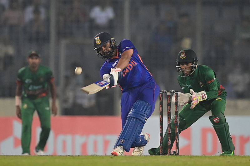 India's captain Rohit Sharma (C) plays a shot during the second one-day international (ODI) cricket match between Bangladesh and India at the Sher-e-Bangla National Cricket Stadium in Dhaka on 7 December 2022.