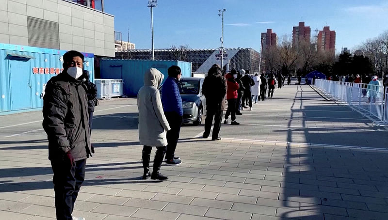 Residents queue to receive a nasal spray Covid-19 booster vaccine in Beijing, China December 17, 2022 in this still image obtained from a video