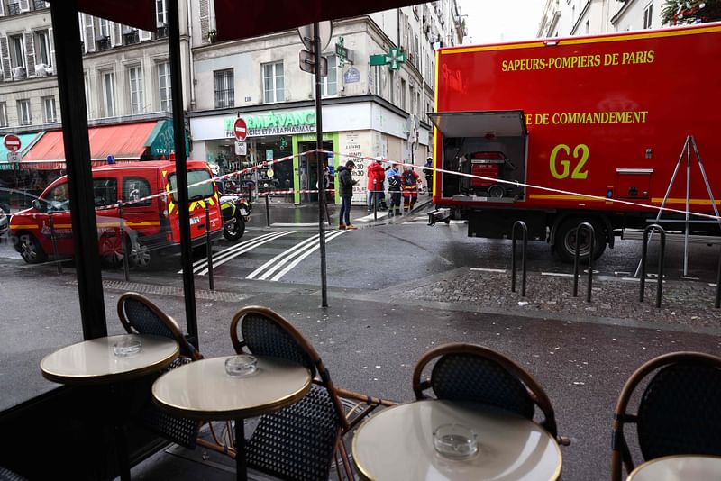 Police tape is used to cordoned off the area following a shooting along rue d'Enghien in the 10th arrondissement, in Paris on December 23, 2022. Three people were killed and four injured in a shooting along rue d'Enghien in central Paris on 23 December 2022, police and prosecutors said, adding that the shooter, in his 60s, had been arrested.