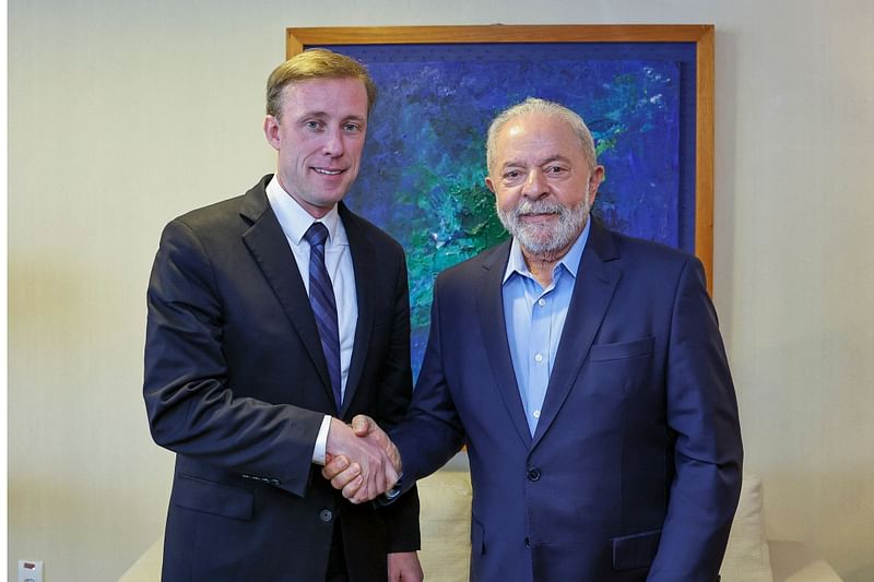 This handout picture released by the Lula da Silva Press office shows Brazil's president-elect Luiz Inacio Lula da Silva (R) and US National Security Advisor Jake Sullivan standing for a picture during a meeting in Brasilia, on 5 December, 2022