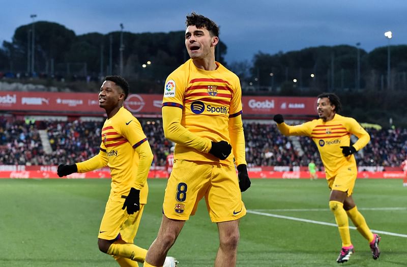 Barcelona's Spanish midfielder Pedri celebrates scoring the opening goal next to Barcelona's Spanish forward Ansu Fati during the La Liga match between Girona FC and FC Barcelona at the Montilivi stadium in Girona on 28 January, 2023