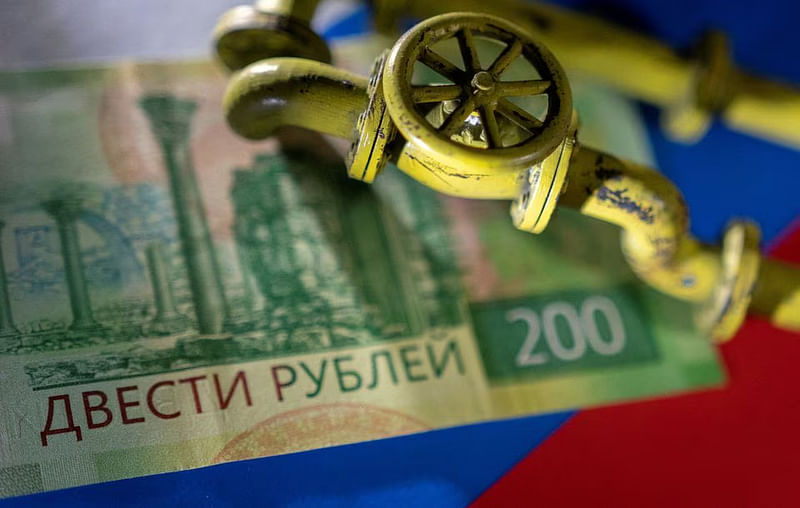 A model of the natural gas pipeline is placed on Russian Rouble banknote and a flag in this illustration taken, on 23 March, 2022.