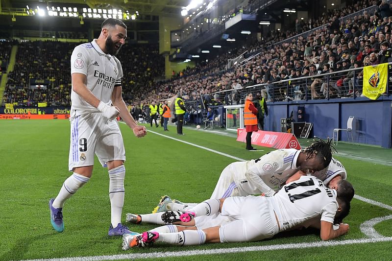 Real Madrid's Spanish midfielder Dani Ceballos (Down) celebrates with teammates after scoring his team's third goal during the Spain's Copa del Rey (King's Cup), round of 16 football match between Villarreal CF and Real Madrid CF at La Ceramica stadium in Vila-Real, near Valencia, on January 19, 2023