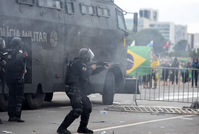 Security forces confront supporters of Brazilian former President Jair Bolsonaro invading Planalto Presidential Palace in Brasilia on January 8, 2023