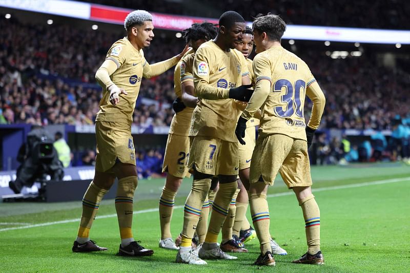 Barcelona's French forward Ousmane Dembele (C) celebrates scoring a goal during the Spanish League football match between Club Atletico de Madrid and FC Barcelona at the Wanda Metropolitano stadium in Madrid on 8 January, 2023