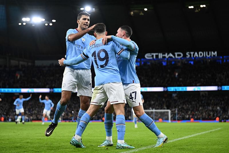 Manchester City's Argentinian striker Julian Alvarez (C) celebrates with teammates after scoring their second goal from the penalty spot during the English FA Cup third round football match between Manchester City and Chelsea at the Etihad Stadium in Manchester, north-west England, on 8 January, 2023