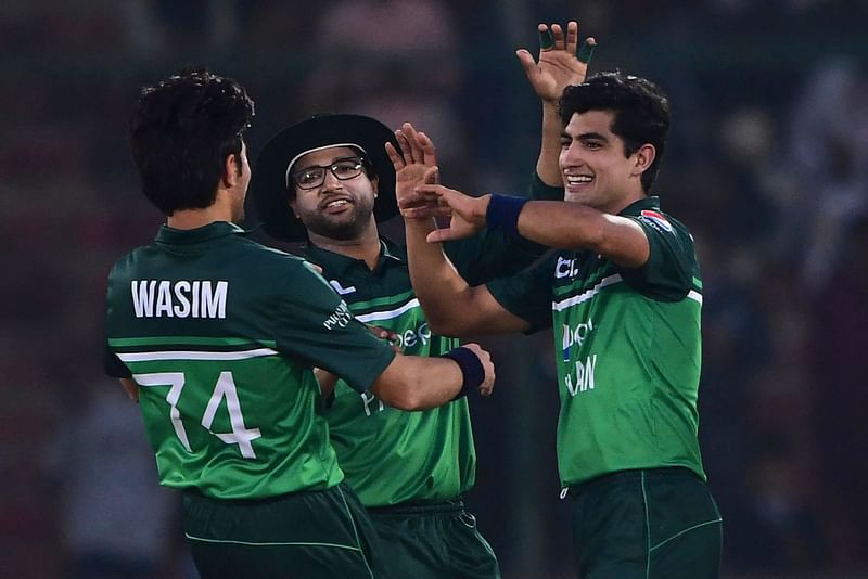 Pakistan's Naseem Shah (R) celebrates with teammates after taking the wicket of New Zealand's Henry Shipley (not pictured) during the first one-day international (ODI) cricket match between Pakistan and New Zealand at the National Stadium in Karachi on 9 January, 2023