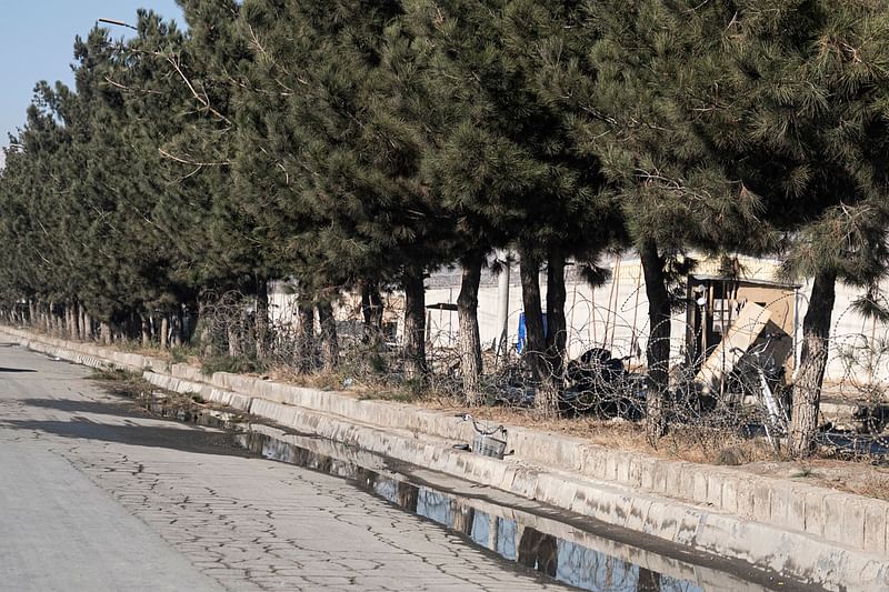 This picture taken on 1 January, 2023 shows the site of an explosion next to the entrance to a military airfield in Kabul. An explosion at the entrance to a military airfield in the Afghan capital killed and wounded several people on 1 January, an official told AFP. The cause of the blast at the gate of the facility next to Kabul's international airport was unclear, interior ministry spokesman Abdul Nafy Takor said.