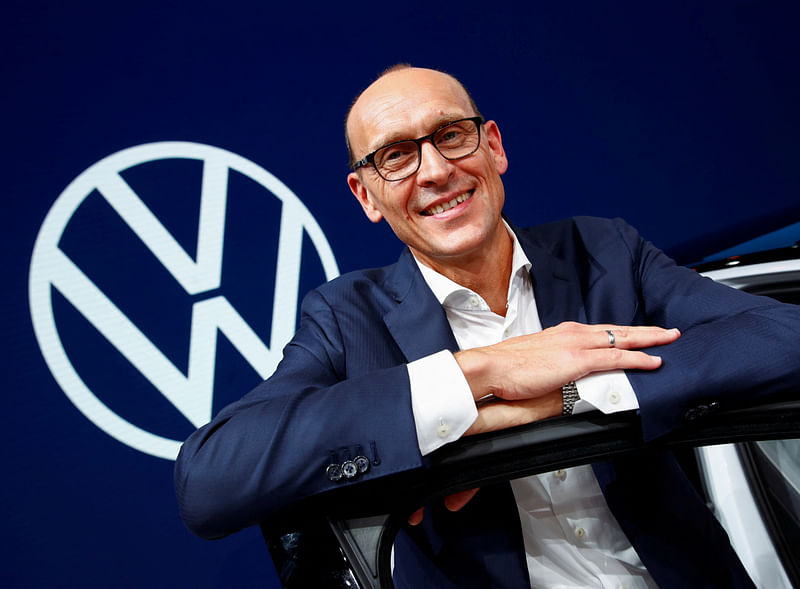 Ralf Brandstaetter, CEO of the Volkswagen Passenger Cars brand gestures in front of the revised logo of German carmaker Volkswagen AG during a preview of the world’s biggest automaker at the international Frankfurt Motor Show IAA in Frankfurt, Germany on 9 September, 2019