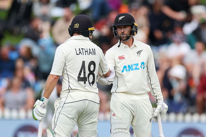 New Zealand's Devon Conway celebrates 50 runs with teammate Tom Latham during day three of the second cricket Test match between New Zealand and England at the Basin Reserve in Wellington on 26 February, 2023