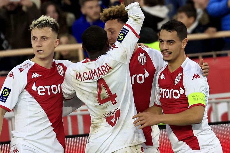 Monaco's French forward Wissam Ben Yedder (R) celebrates with team mates after scoring a goal during the French L1 football match between Monaco and Paris Saint-Germain (PSG) at the Louis II stadium in Monaco on 11 February, 2023