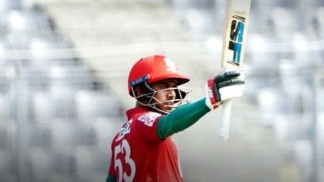 Fortune Barishal batsman Mehidy Hasan Miraz raises his bat after completing his half-century in the eliminator match against Rangpur Riders in the Bangladesh Premier League (BPL) 2023 at the Sher-e-Bangla National Cricket Stadium in Dhaka on 12 February, 2023