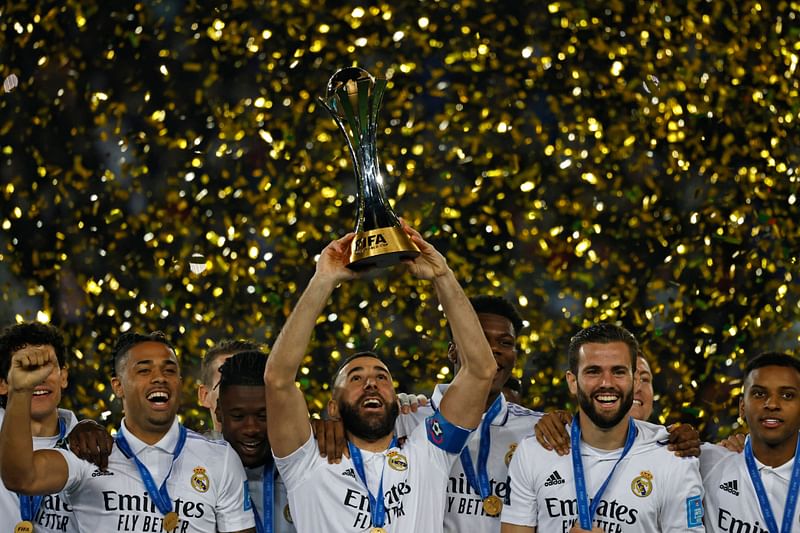 Real Madrid's French forward Karim Benzema (C) celebrates with the trophy at the end of the FIFA Club World Cup final football match between Spain's Real Madrid and Saudi Arabia's Al-Hilal at the Prince Moulay Abdellah Stadium in Rabat on 11 February, 2023