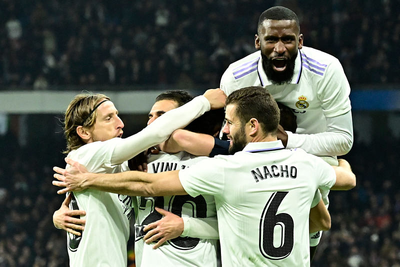 Real Madrid players celebrate their second goal scored by Real Madrid's Brazilian forward Vinicius Junior during the La Liga match between Real Madrid CF and Valencia CF at the Santiago Bernabeu stadium in Madrid on 2 February, 2023