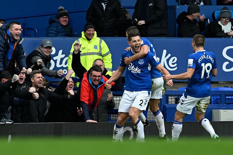 Everton's English defender James Tarkowski (C) celebrates with teammates after scoring a goal during the English Premier League football match between Everton and Arsenal at Goodison Park in Liverpool, north-west England, on 4 February, 2023