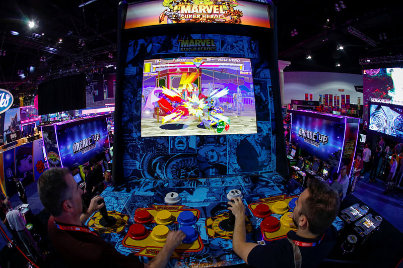 Attendees play a video game at E3, the annual video games expo experience the latest in gaming software and hardware in Los Angeles, California, US, 12 June, 2019.