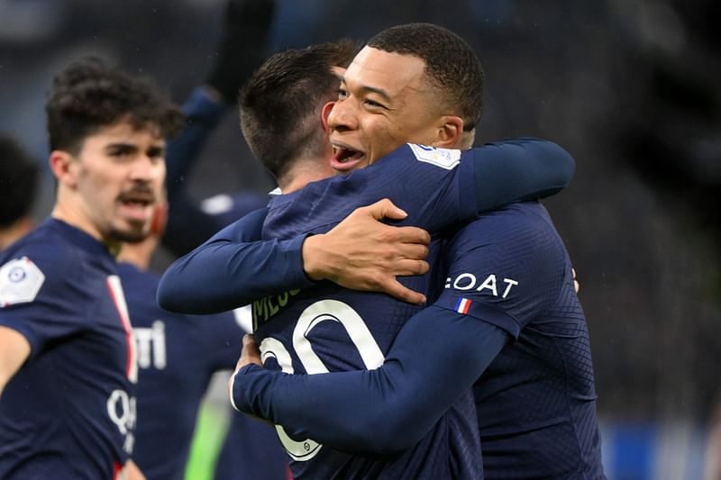 Paris Saint-Germain's Argentine forward Lionel Messi (C) is congratulated by Paris Saint-Germain's French forward Kylian Mbappe after scoring his team's second goal during the French L1 football match between Olympique Marseille (OM) and Paris Saint-Germain (PSG) at the Velodrome stadium in Marseille, southern France on 26 February, 2023