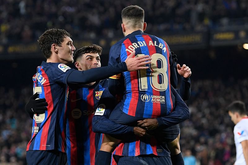 Barcelona's Spanish defender Jordi Alba (C) celebrates with teammates after scoring his team's first goal during the Spanish league football match between FC Barcelona and Sevilla FC at the Camp Nou stadium in Barcelona, on 5 February, 2023