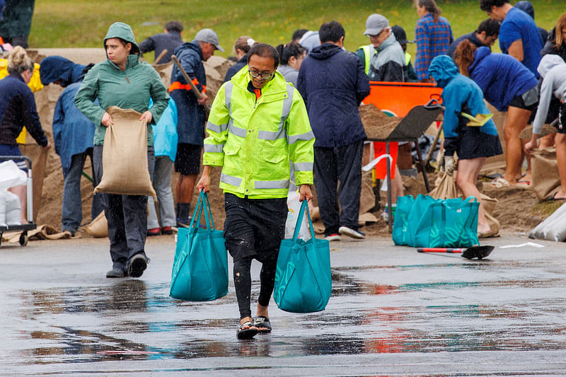 People fill up sandbags at a public collection point in preparation for the arrival of Cyclone Gabrielle in Auckland, New Zealand, 12 February, 2023.