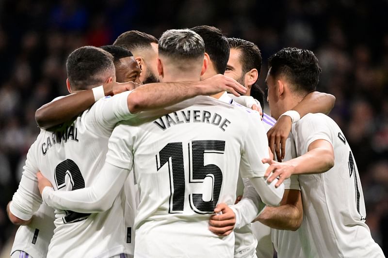 Real Madrid's Spanish midfielder Marco Asensio (C) celebrates with teammates after scoring his team's first goal during the Spanish League football match between Real Madrid CF and Elche CF at the Santiago Bernabeu stadium in Madrid on 15 February, 2023